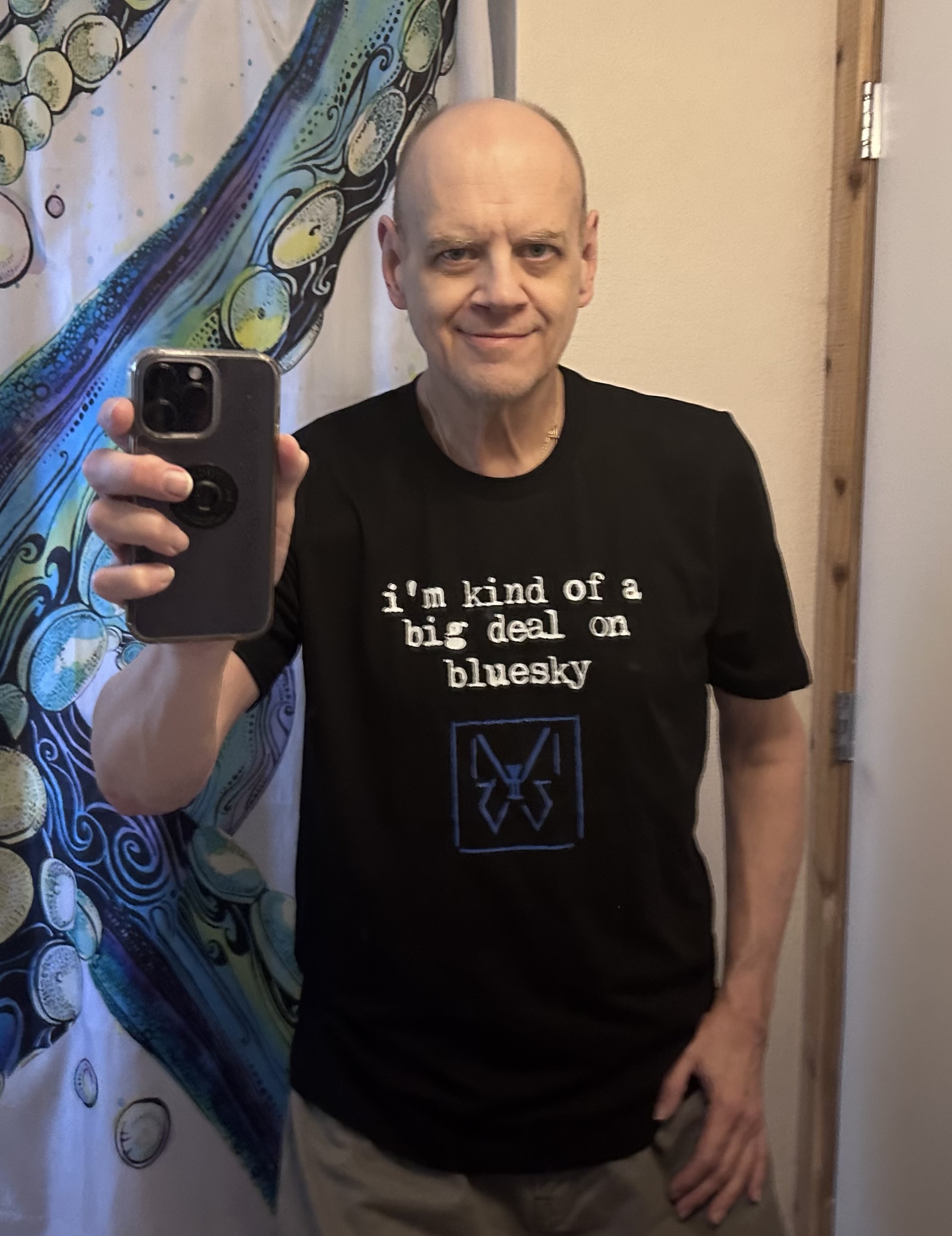 Chuck Evans, portrait, wearing a tshirt that says he's a pretty big guy on Bluesky